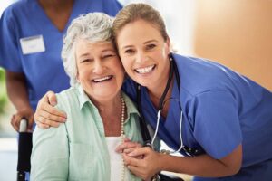 A senior resident sitting with a caregiver at a small table, having a respectful and private conversation.